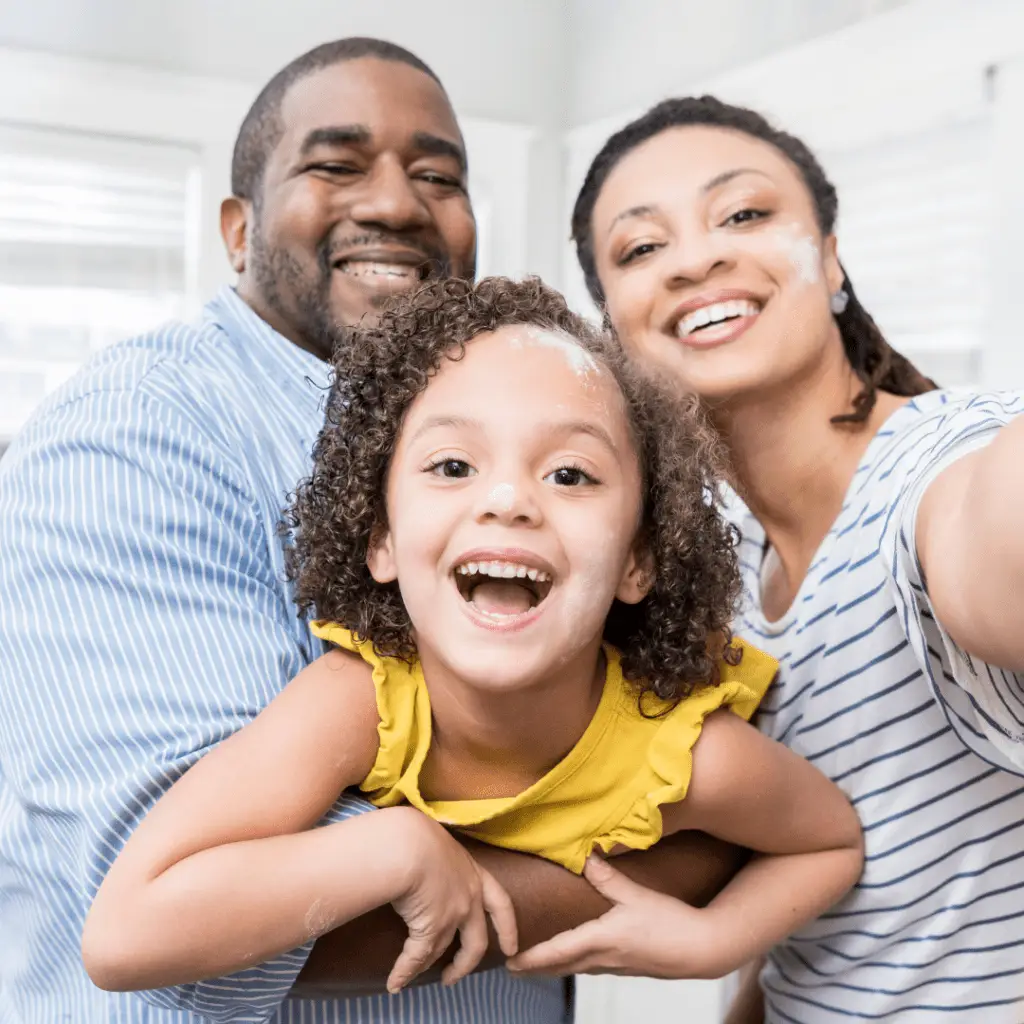 parents holding their child in their arms