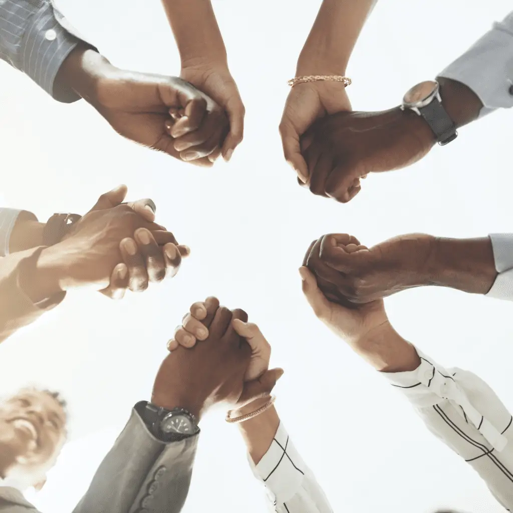 people holding hands together in a circle